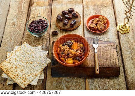 Jewish Dish Shuttle With Meat In A Dish On A Wooden Table Near Matzo And Ingredients. Horizontal Pho