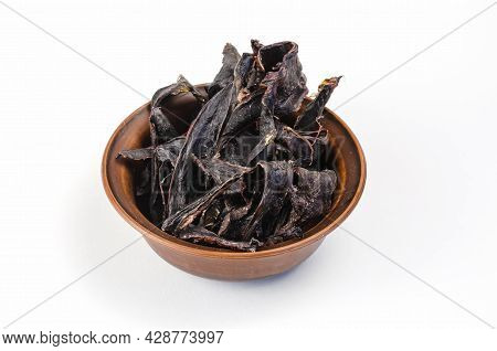 Dried Dog Treats In A Brown Clay Bowl On A White Background. Thin Slices Of Dehydrated Beef Heart. T