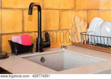 Modern Black Stainless Steel Kitchen Mixer In The Sink, Ocher Ceramic Tiles.