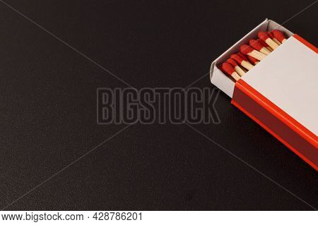 An Open Matchbox With A Blank White Label On A Black Background.
