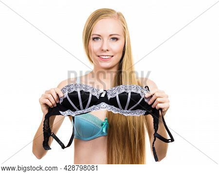 Young Blonde Woman Trying On Black Bra With White Lace. Bra Has Removed The Underwire. Bosom Concept