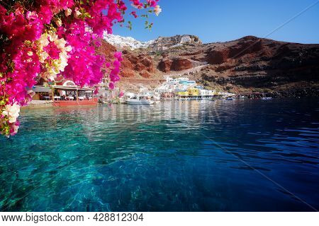Amoudi Bay, Port Of Oia, Santorini Greece At Sunny Summer With Flowers