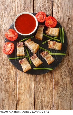 Lechon Kawali Or Crispy Deep Fried Pork Belly Served With Sweet And Sour Sauce Closeup In The Slate 