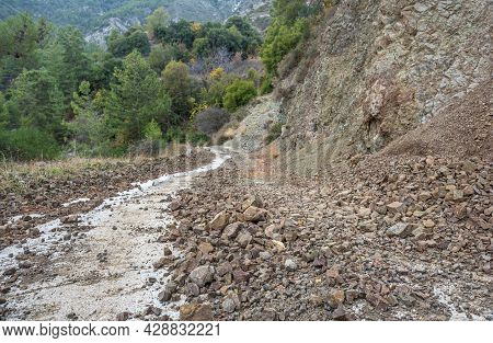 Falling Rocks Danger. Countryside Road Blocked By A Rockfall In Mountain Area Of Cyprus