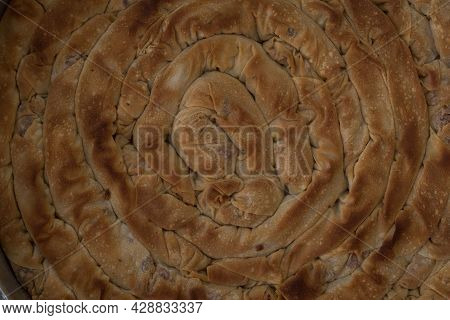 Baked Homemade Traditional Greek Cheese Twist Pie In Iron Oven Pan With Filo, Spinach, Mizithra And 
