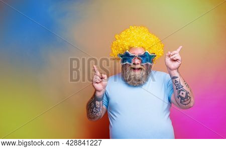 Fat Happy Man With Beard, Tattoos And Sunglasses Dances Music On A Disco