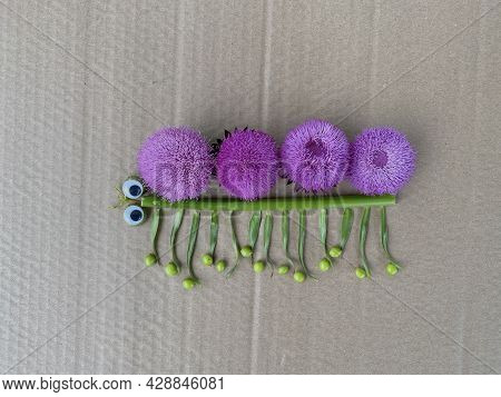 A Caterpillar Of Pink Flowers And Green Plants, Kids Craft For Playing Outside.