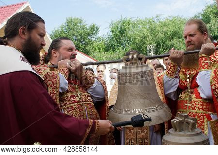 Orthodox Priests Raise The Bell For Subsequent Installation On The Bell Tower Of A Christian Church.