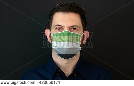 Portrait Of An Adult Man Wearing A Lgbt Aromantic Flag Colors Facial Mask. Lgbt Gay Rights Concept W