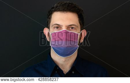 Portrait Of An Adult Man Wearing Algbt Bisexual Flag Colors Facial Mask. Lgbt Gay Rights Concept Wit