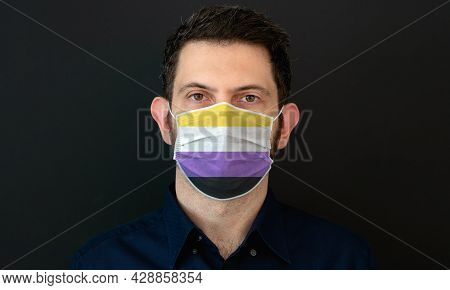 Portrait Of An Adult Man Wearing A Lgbt Non-binary Flag Colors Facial Mask. Lgbt Gay Rights Concept 
