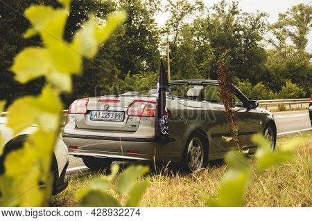Chernigov, Ukraine - July 24, 2021: Saab Car On The Road. Saab 9-3 Cabriolet On The Background Of Tr