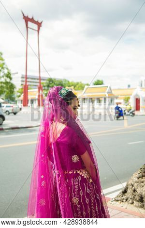 Portrait Asian Woman In A Margenta Indian Tradition Sari, She Is Looking At Side While Traveling In 
