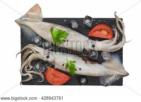 Seafood And Gourmet Food, Raw Squid With Tentacles With Tomatoes, Spices And Parsley On A Stone Plat