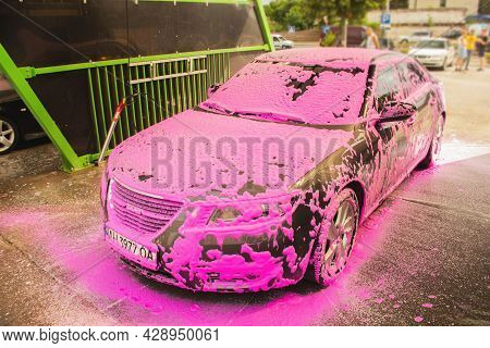 Chernigov, Ukraine - July 24, 2021: Saab Car At A Car Wash. Gray Saab 9-5 Car In Pink Foam At A Self