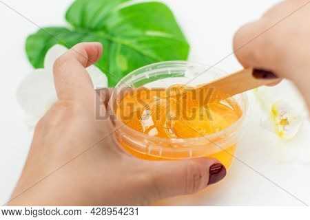 Sugar Paste In A Transparent Jar On A White Background. A Master Stir The Sugar Paste Before Removin