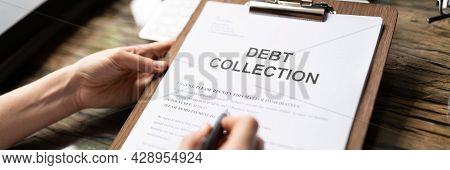 Woman Reading Debt Collection Notice Letter At Desk