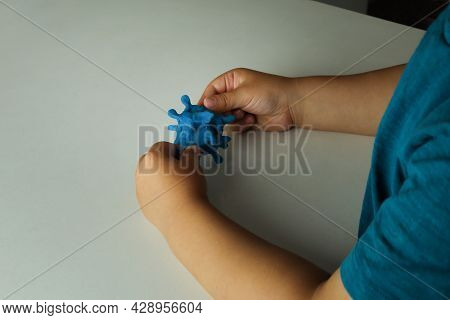 Little Boy Molding With Plastiline Coronavirus. Covid-19 Virus And Kids. Plasticine, Play Dough.