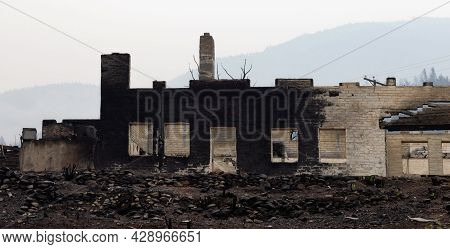 Fire Debris Of Houses In A Small Town With Smoke In Sky. Caused By Forest Wildfires In Lytton, Briti