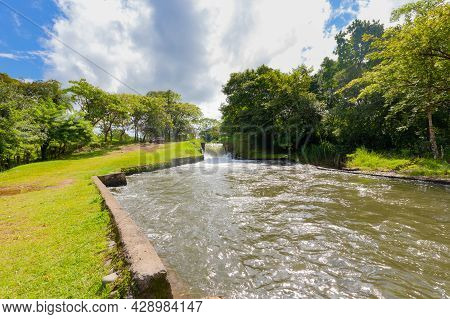 Panama Dolega, August 5, Artificial Waterfall Canal Creek, Panoramic View On A Sunny Day. Shoot On A