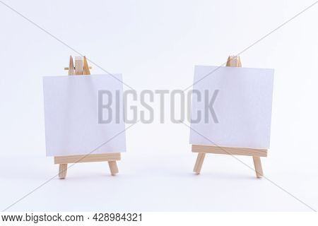 Two Wooden Easels Miniature With Blank White Square Canvas For Artists And Painters - Mockup. Mini W