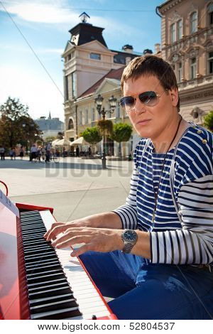 Young pianist play on his piano with bright emotions, Novi Sad, Serbia.