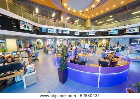 MOSCOW - MAR 5: Employees in office buildings news agency RIA Novosti with tables around and many screens on March 5, 2013 in Moscow, Russia.
