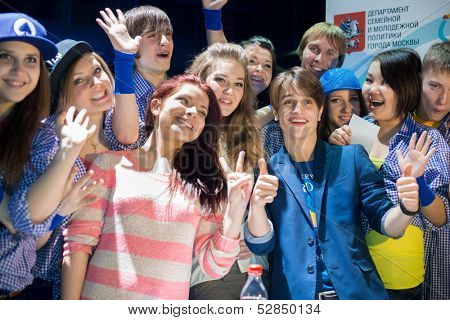 MOSCOW - MAR 30: Dutch singer, winner of the Junior Song Contest Eurovision 2009 Ralf Mackenbach with ten fans teenagers in Moscow Hall Club on Mart 30, 2013 in Moscow, Russia.