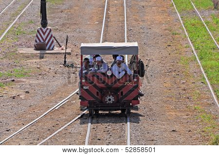 Railroadmen arrive by handmade vehicle.