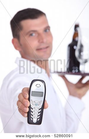 Waiter holding cell phone
