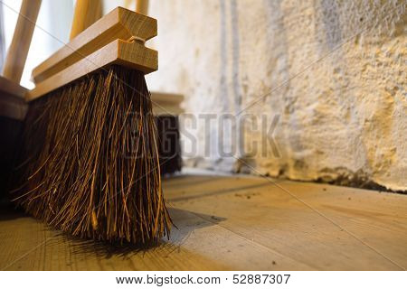 Large Brooms On Wooden Floor Housework