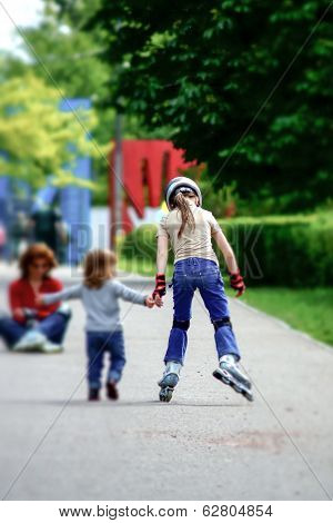Young Girl Skating With Little Syster