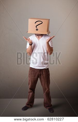 Young man standing and gesturing with a cardboard box on his head with question mark