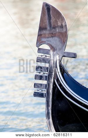 The prow of a gondola on the Grand Canal in Venice, Italy. The prow, or ferro, is to protect the boats in a collision. The six prongs represent city districts and the top the Doge's cap, supposedly.