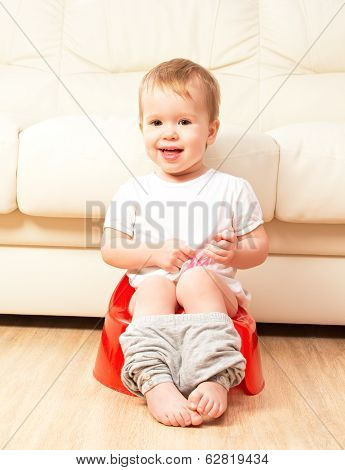 Baby Sitting On Potty In Toilet