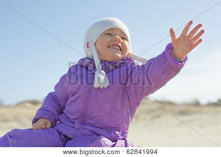 Cheerful child girl extending hand