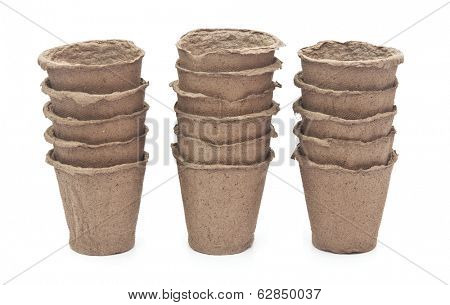 pile peat pots for growing seedlings, isolated on white background 