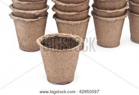pile peat pots for growing seedlings, isolated on white background 