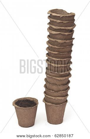 pile peat pots for growing seedlings, isolated on white background 