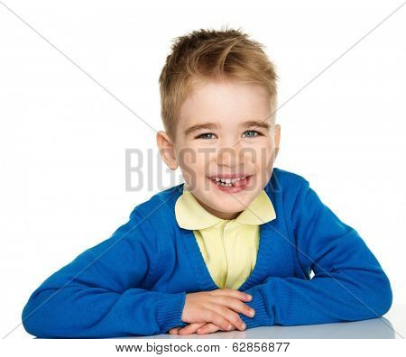 Sly little boy in blue cardigan and yellow shirt 