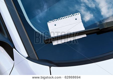 message under a windshield wiper