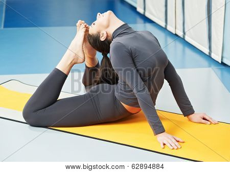 Happy smiling woman at gymnastic physical training fitness exercise in gym