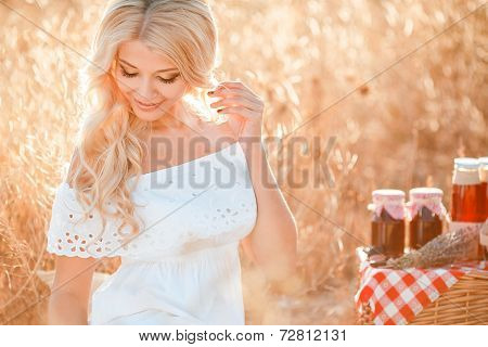Portrait of a beautiful young woman with a basket of grapes