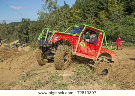 Small Red Off Road Car Is Hitting A Steep Hill