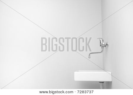 Sink in an empty big white room