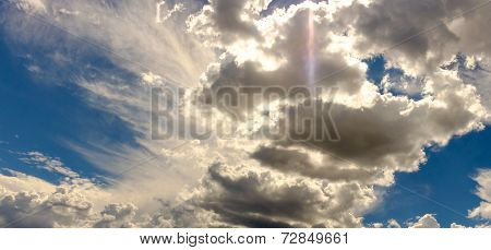 Sundog flare in high clouds in a bright blue sky