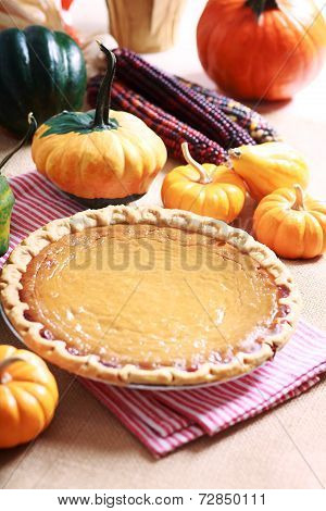 Pumpkin Pie With Autumn Pumpkins And Corn