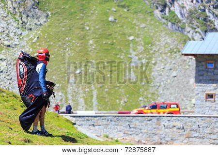 Unidentified paraglider in Balea Lake Fagaras Mountain Romania.