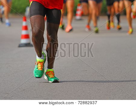 Athlete Runs Down The Street During The Race Outdoors