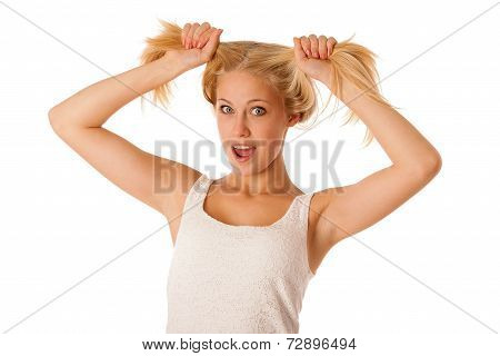 Beautiful Young Blonde Woman Holds Hair In Her Hand Gesturing Excitement Isolated Over White Backgro